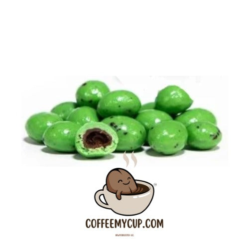 Coffee My Cup Sweet Treats Collection: Café Mint Espresso Beans: Green chocolate-covered candies with a small cartoon character and 'CoffeeMyCup.com' text on a white background