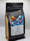 Coffee My Cup: Island Fun Coffee, Coffee bag with a colorful label featuring a person surfing on a wave, on a white background.