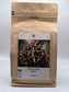 Coffee My Cup: United We Stand Specialty Coffee in kraft paper coffee bag with a photo of people and an American flag on a white background
