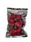 Coffee My Cup Sweet Treats Collection: Prosecco Berry Bliss – 4oz Bag: Red spherical candies with brown centers in a clear plastic bag on a gray background