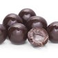 Coffee My Cup Sweet Treats Collection: Cherry Cordials: Chocolate-covered candies with a cracked open one on a white background