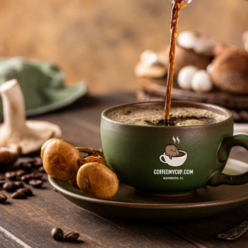 Coffee My Cup: Mushroom Coffee Dark Roast – Travel Indulgence Collection, green mug with coffee being poured, surrounded by coffee beans and mushrooms.