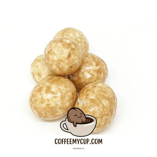 Stack of round, beige-colored treats with a small illustration of a bear in a cup and 'COFFEEMYCUP.COM' text on a white background.