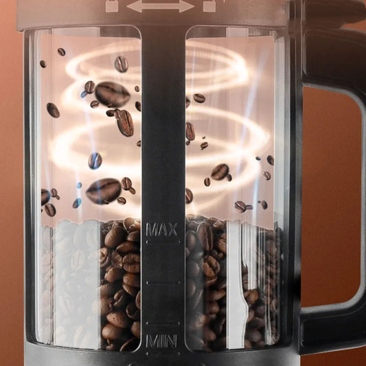 Coffee My Cup: Close-up of a coffee roaster with coffee beans inside, on a brown background.