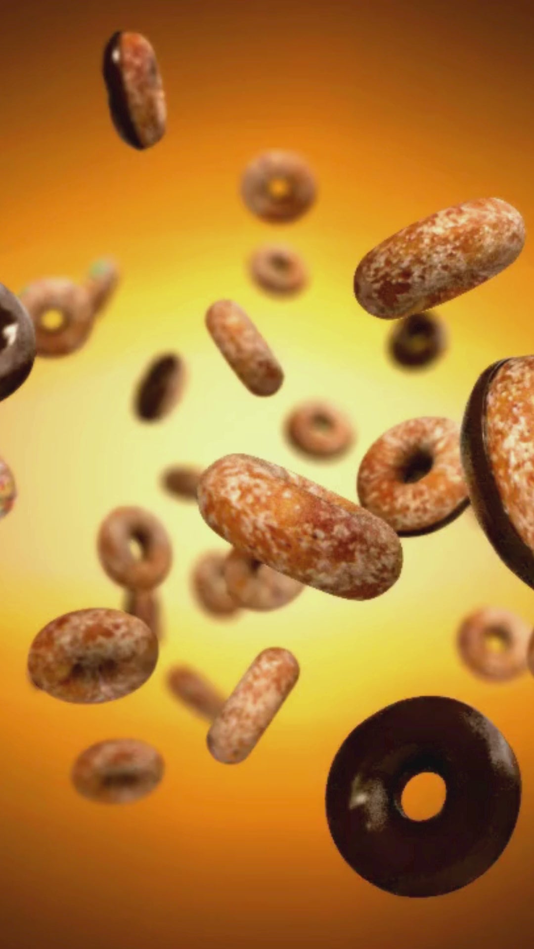 A stylized slow-motion video from Coffee My Cup showing various delicious donuts falling gently against a warm background, representing the perfect pairing for a cup of coffee.Video Link: https://youtube.com/shorts/-2pTwqucZhc?si=ndEr1V5J0dJF7CwD